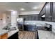 Stylish kitchen featuring dark wood cabinets, stainless steel appliances, and granite countertops, perfect for cooking at 1809 Lazy Hill Ranch Way, North Las Vegas, NV 89081