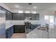 Modern kitchen featuring granite countertops, stainless steel appliances, and ample cabinet space at 1809 Lazy Hill Ranch Way, North Las Vegas, NV 89081