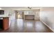 Bright living room features stylish dark wood floors, large windows, and seamless flow to the kitchen at 1809 Lazy Hill Ranch Way, North Las Vegas, NV 89081