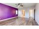 Large main bedroom with wood floors, ceiling fan, and ensuite bathroom at 1809 Lazy Hill Ranch Way, North Las Vegas, NV 89081