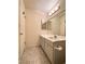 Bright bathroom with vanity, white cabinets, light fixture and wood look flooring at 2064 Mesquite Ln # 303, Laughlin, NV 89029
