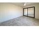 Bright bedroom features a ceiling fan, closet with mirrored doors, and light gray wood-look flooring at 2064 Mesquite Ln # 303, Laughlin, NV 89029