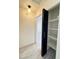 Hallway closet with black door ajar showcasing interior shelves for storage and organization at 2064 Mesquite Ln # 303, Laughlin, NV 89029