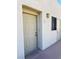 A close-up view of the unit's exterior front door and surrounding wall at 2064 Mesquite Ln # 303, Laughlin, NV 89029