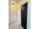 Hallway featuring grey laminate flooring and a dark storage closet with long silver handles at 2064 Mesquite Ln # 303, Laughlin, NV 89029