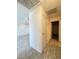Hallway featuring grey laminate flooring, access to rooms, and a white storage closet with gold knob at 2064 Mesquite Ln # 303, Laughlin, NV 89029