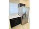 Kitchen featuring stainless steel refrigerator, white countertops, and dark cabinets at 2064 Mesquite Ln # 303, Laughlin, NV 89029