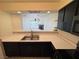 Bright kitchen featuring stainless steel sink, ample counter space, and a view of the living area at 2064 Mesquite Ln # 303, Laughlin, NV 89029