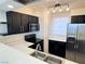 Well-lit kitchen with modern appliances, black cabinets, and sleek countertops at 2064 Mesquite Ln # 303, Laughlin, NV 89029