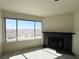 Cozy living room with large windows overlooking city, complemented by a charming black-tiled fireplace at 2064 Mesquite Ln # 303, Laughlin, NV 89029