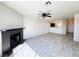 Bright and airy living room with tiled fireplace, ceiling fan, and an open floor plan into the kitchen at 2064 Mesquite Ln # 303, Laughlin, NV 89029