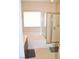 Bright bathroom featuring a large window, soaking tub, and a glass enclosed shower at 2679 Lochleven Way, Henderson, NV 89044