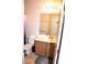 Bathroom with single vanity, large mirror, and commode at 2679 Lochleven Way, Henderson, NV 89044