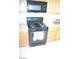 Picture of a black oven with black microwave and beige countertops and cabinets at 2679 Lochleven Way, Henderson, NV 89044