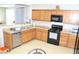 Bright kitchen featuring wood cabinets and black appliances at 2679 Lochleven Way, Henderson, NV 89044