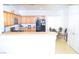 Bright kitchen featuring wood cabinets, black appliances, and a cozy dining area with a glass-top table at 2679 Lochleven Way, Henderson, NV 89044