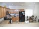Bright kitchen featuring wood cabinets, black appliances, and a cozy dining area at 2679 Lochleven Way, Henderson, NV 89044