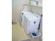 A functional laundry room featuring a washing machine, dryer, and ironing board at 2679 Lochleven Way, Henderson, NV 89044