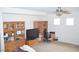 Living room with media center, desk, and comfortable seating at 2679 Lochleven Way, Henderson, NV 89044