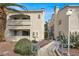 Beautiful condo complex with lush landscaping, blue railings, and well-maintained grounds at 2725 S Nellis Blvd # 1033, Las Vegas, NV 89121