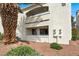A sunny shot of the building exterior, accented by desert landscape and architectural blue trim at 2725 S Nellis Blvd # 1033, Las Vegas, NV 89121