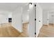 Bright hallway featuring wood floors, white trim, and an open doorway to an adjacent room at 2725 S Nellis Blvd # 1033, Las Vegas, NV 89121