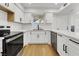 Updated kitchen with stainless steel appliances, white cabinets, and quartz countertops at 2725 S Nellis Blvd # 1033, Las Vegas, NV 89121