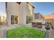 Charming backyard featuring artificial grass, pavers and patio furniture at 31 Castleton Tower Ct, Henderson, NV 89011