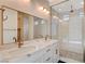 Modern bathroom featuring double sinks, stone countertops, and decorative backsplash and a glass enclosed shower at 31 Castleton Tower Ct, Henderson, NV 89011