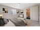 Comfortable bedroom featuring carpet floors, a large window, and neutral paint and adjacent bathroom at 31 Castleton Tower Ct, Henderson, NV 89011