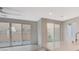 Bright living room with sliding glass doors leading to the backyard, neutral color palette, and contemporary design at 31 Castleton Tower Ct, Henderson, NV 89011