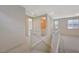 Staircase leading to the second floor with neutral carpet and paint, with an adjacent bathroom and hall at 31 Castleton Tower Ct, Henderson, NV 89011