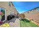 Spacious backyard with patio, lush lawn, play structure, and private block fencing at 3164 Bormida Ave, Henderson, NV 89044