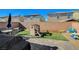 Private backyard featuring a playground, patio, and well-maintained landscaping at 3164 Bormida Ave, Henderson, NV 89044