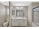 Bright bathroom featuring a double sink vanity, neutral color palette, and walk-in shower at 3164 Bormida Ave, Henderson, NV 89044
