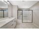 Bathroom with walk-in shower and tile flooring complemented by a modern double sink vanity at 3164 Bormida Ave, Henderson, NV 89044