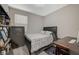 Cozy bedroom featuring a modern bed, a large window, and an adjacent workspace at 3164 Bormida Ave, Henderson, NV 89044