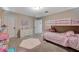 Bright bedroom featuring a bunk bed, soft pink accents, and a plush area rug at 3164 Bormida Ave, Henderson, NV 89044