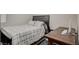 Comfortable bedroom with a checkered bedspread and a convenient workspace at 3164 Bormida Ave, Henderson, NV 89044