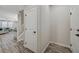 Bright foyer with wood-look flooring, stairs, and access to the living area at 3164 Bormida Ave, Henderson, NV 89044