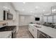 Open concept kitchen with stainless steel appliances, center island and adjacent living area at 3164 Bormida Ave, Henderson, NV 89044