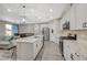 Modern kitchen with white cabinets, stainless steel appliances, and a large island perfect for entertaining at 3164 Bormida Ave, Henderson, NV 89044