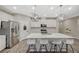 Well-appointed kitchen with island seating, modern lighting, and stainless steel appliances at 3164 Bormida Ave, Henderson, NV 89044