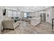 Open-concept living area with wood flooring, dining area, and modern kitchen at 3164 Bormida Ave, Henderson, NV 89044