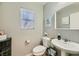 Well-lit half bathroom with a stylish vanity, decorative mirror, and modern fixtures at 3177 Bivona Walk, Henderson, NV 89044