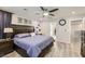 A primary bedroom with a king size bed, ceiling fan and a walk-in closet at 3177 Bivona Walk, Henderson, NV 89044