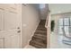 A lovely staircase with hardwood steps and white banister is naturally lit by a skylight window at 3177 Bivona Walk, Henderson, NV 89044