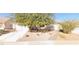 Charming single-story home with low maintenance desert landscaping, and a two car garage at 327 Perry Ellis Dr, Henderson, NV 89014