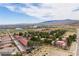 Expansive aerial shot of a desert community near a lake, showcasing red-roofed buildings with ample parking and tree lined streets at 3740 Desert Marina Dr # 3, Laughlin, NV 89029