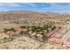 Panoramic aerial view of a vibrant community with red-tiled roofs, green trees, and scenic mountain backdrop in a sunny locale at 3740 Desert Marina Dr # 3, Laughlin, NV 89029